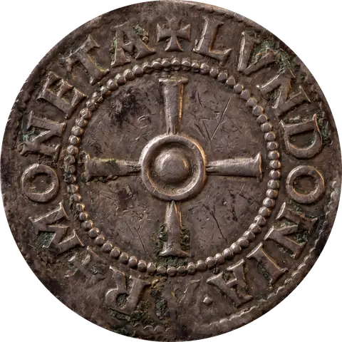 The reverse of the same silver coin: a cross with flared arms around a raised central boss inside a beaded circle, with raised lettering around the rim that includes LVNDONIA.
